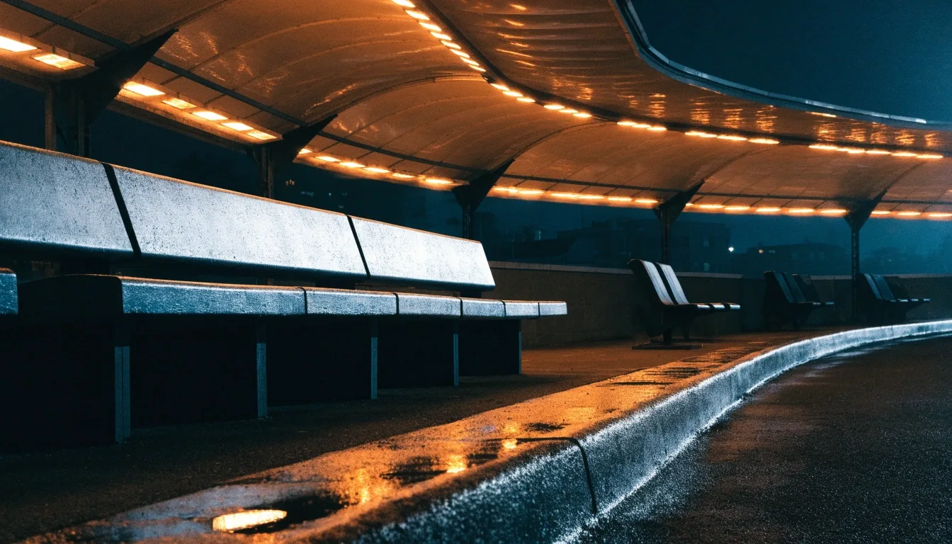 Covered shuttle bay at night with wet kerb